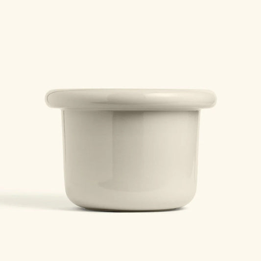 Glossy polar white ceramic planter with a wide lip and rounded edges, perfect for modern home decor.