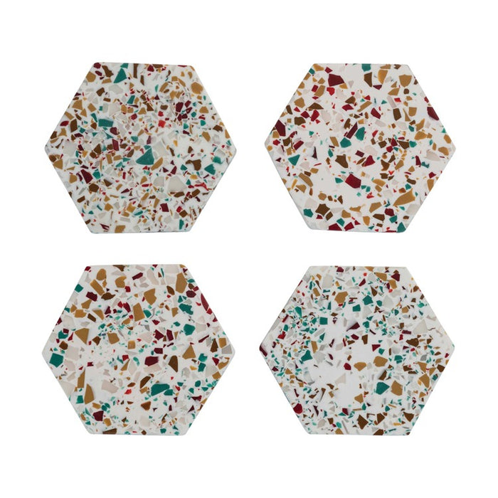 Set of four hexagon resin coasters with multicolored terrazzo pattern for stylish home decor.