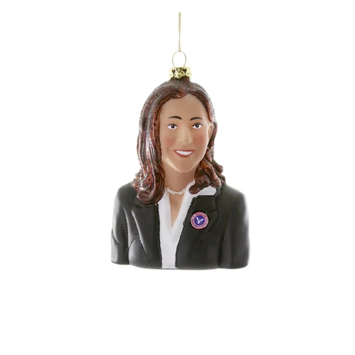 Decorative ornament of a woman with brown hair wearing a black blazer and white blouse, hanging loop attached.