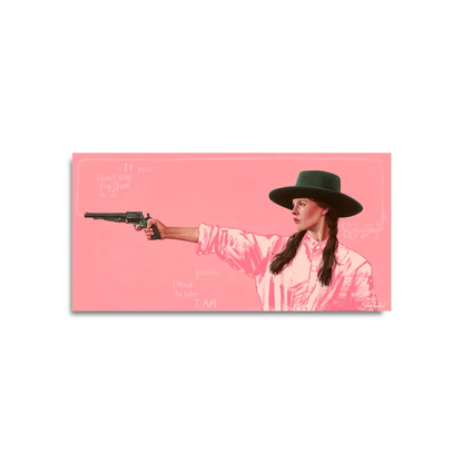 Woman in a pink shirt and dark hat aiming a vintage revolver against a solid pink background artwork