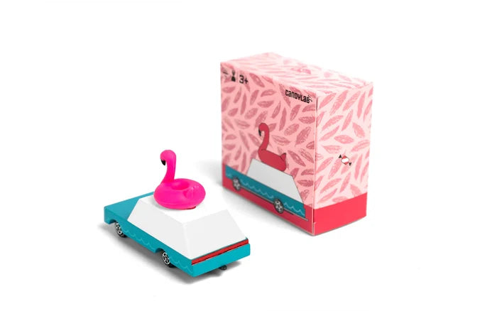 Pink toy car with a flamingo figure on top next to a pink patterned box with flamingo design