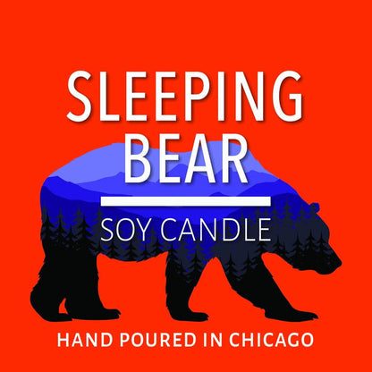 Illustration of a bear silhouette with blue mountain and forest landscape inside on a red background for soy candle branding.