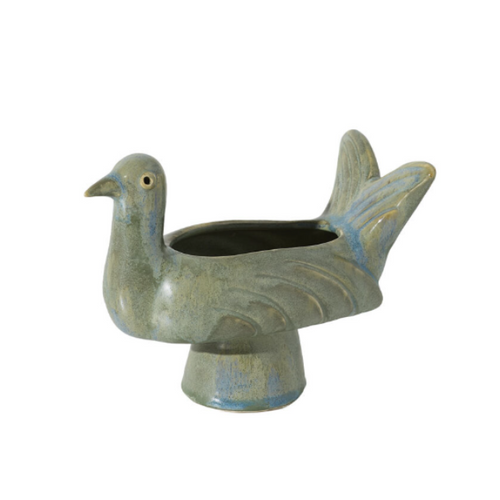 A ceramic bird-shaped planter shaped like a pigeon, featuring a textured glaze in muted blue-gray and brown tones with a small gold accent on the eye, set against a plain white background.