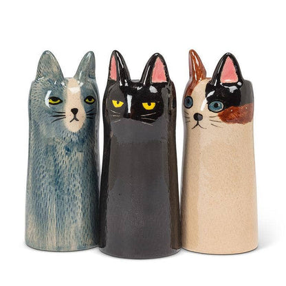 Three ceramic cat-shaped vases in blue, black, and beige with distinct facial expressions and painted details