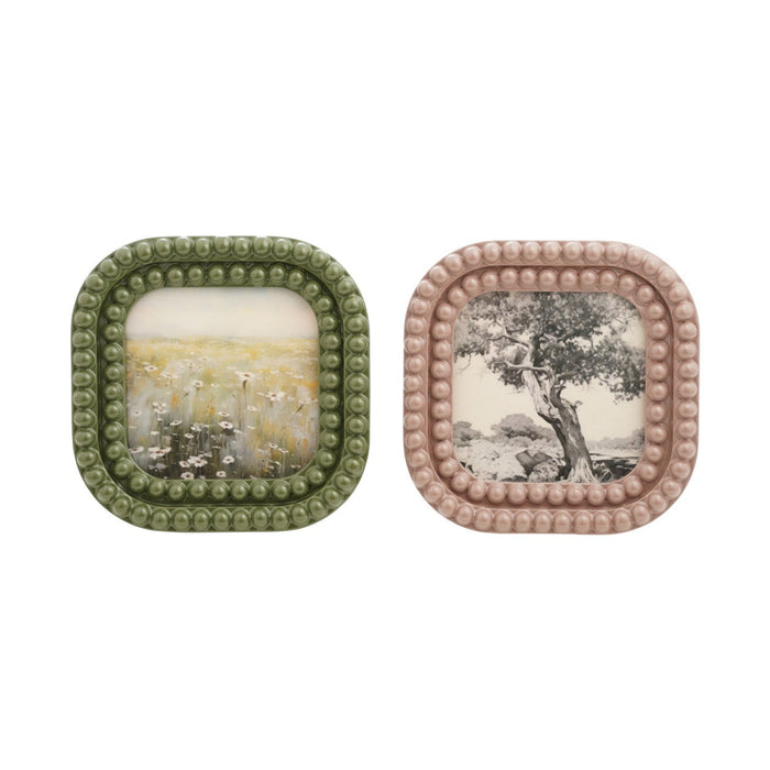 Two square decorative plates with beaded edges on a white background