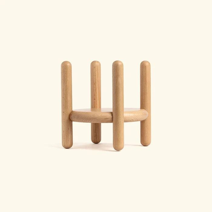 Wooden geometric sculpture on a beige background