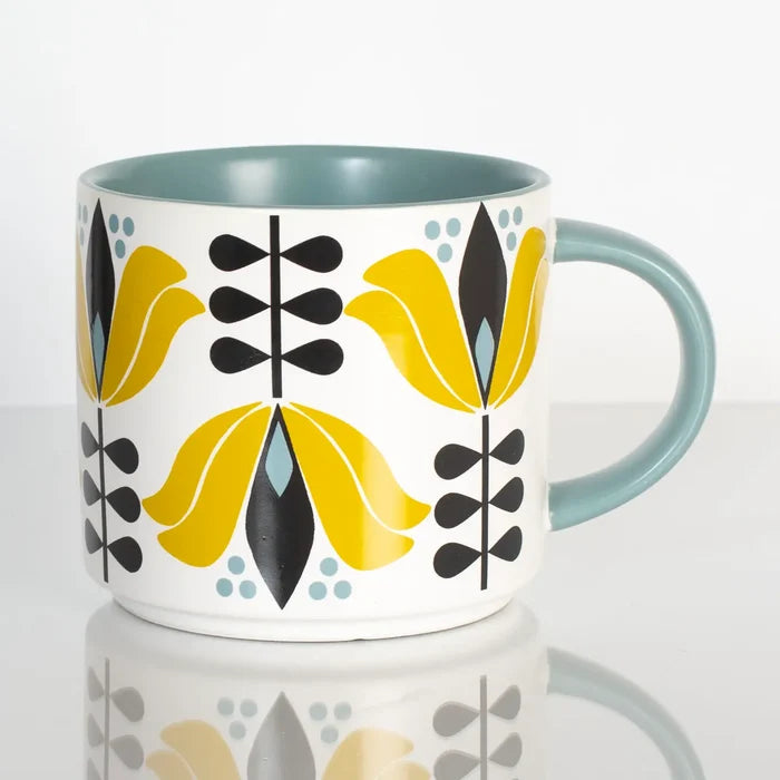 Ceramic mug with yellow lotus floral pattern and muted blue handle and interior in midcentury style